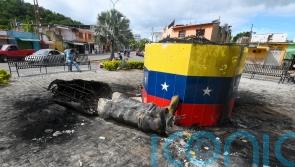 Hugo Chavez statues toppled across Venezuela in post-election unrest