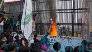Thousands attempt to storm Indonesian parliament after changes to election law