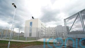 Three appear in court charged with prison murder