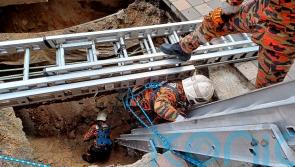 Woman plunges into 26ft hole after pavement collapses in Malaysian capital