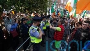 Gardai move in to disperse sit-down anti-immigration protest on Dublin bridge
