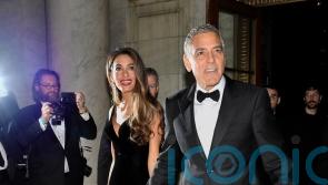 George Clooney plays photographer at star-studded charity event