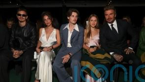 Victoria Beckham supported by family at Paris Fashion Week show