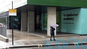 Man arrested following suspected acid attack outside school