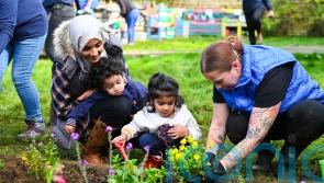 Lottery winners help spruce up garden for toddlers at charity farm