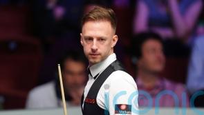Judd Trump brushes off cue confusion to beat John Higgins in Wuhan