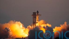 Mechanical SpaceX arms catch returning Starship rocket booster at launch pad