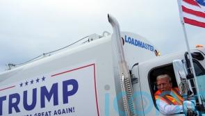 Trump boards garbage truck to highlight Biden remark