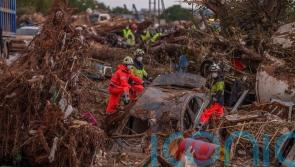 Rains in Barcelona disrupt rail as troops search for flood victims in Valencia