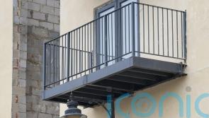 Developer builds balcony at block of flats around street lamppost