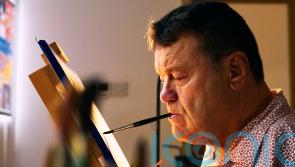 Blind photographer captures mouth and feet artists to challenge stereotypes