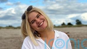 Man arrested and charged after woman, 21, found dead in flat