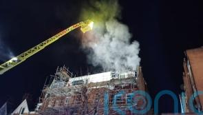 Around 100 firefighters tackling takeaway, flat blaze