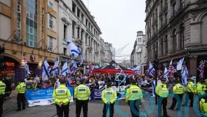 Pro-Palestine group and counter-protesters demonstrate near Christmas shoppers