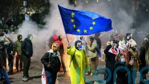 Protesters gather for third night of demonstrations over move to halt EU talks