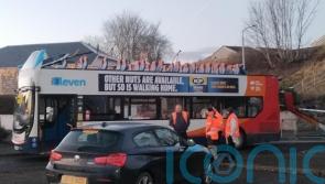 Man charged after bus crashes into railway bridge