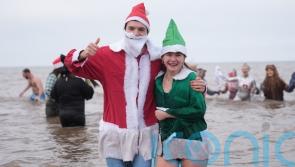 Christmas Day swimmers brave cool sea temperatures for festive dip