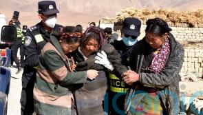 Rescue workers brave cold in search for earthquake survivors