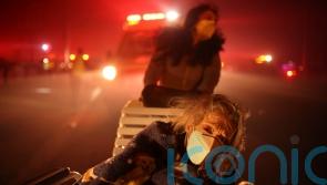 Thousands flee as wildfires burn out of control in Los Angeles