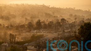 Fires devastating Los Angeles grow more slowly as fierce winds die down