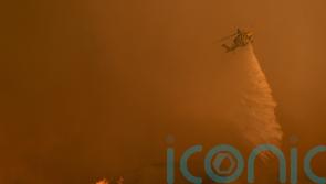 Fire crews scramble to contain Los Angeles blazes before winds return