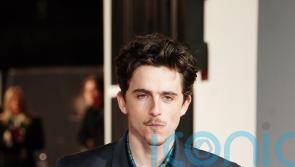 Timothee Chalamet arrives at A Complete Unknown UK premiere on a Lime bike