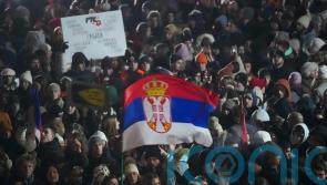 Tens of thousands protest outside Serbian TV HQ after student badly injured