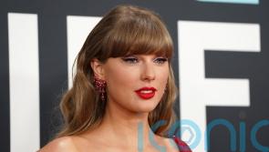 Taylor Swift sparks speculation in all-red ensemble at Grammys