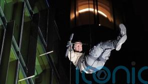 Bear Grylls abseils down London building for celebrity jungle show premiere