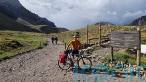 Briton completes cycle and climb from South America’s lowest point to highest
