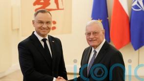 Poland’s president says US assures him it will not reduce its troop presence