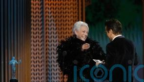 Jamie Lee Curtis presents SAG prize to Colin Farrell, saying he gave her Covid