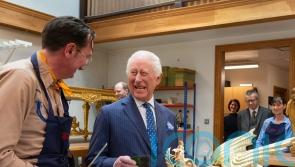 King tries his hand at gilding antique dragon ready for palace visitors