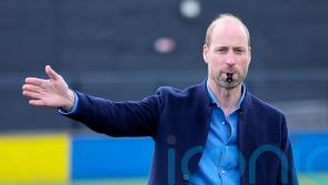 William poses for selfies with schoolchildren and referees football match