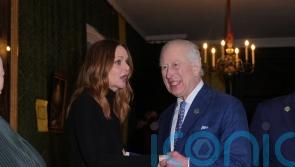 King jokes with guests and views exhibitions at sustainability event
