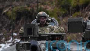 William rides in tank on visit to British troops helping defend Estonia
