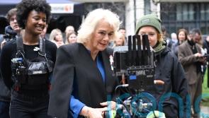 Queen tries her hand as camera assistant on crime drama as ITV marks anniversary
