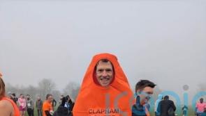 Runner aims to break record for fastest London Marathon run in traffic cone suit