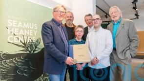 Adrian Dunbar gives rare art book to the Seamus Heaney Centre