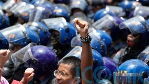 Thousands across the globe march to celebrate May Day and protest over tariffs