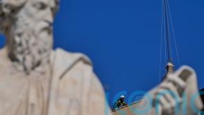 Vatican firefighters install chimney on Sistine Chapel roof for papal election