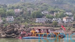 At least three people dead after Chinese tourist boats capsize during storm