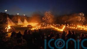 Spectators gather for ancient Celtic fire procession that welcomes summer