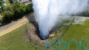 Residential street flooded as burst main shoots 100ft jet of water into the air