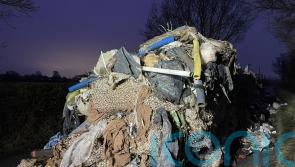 Man and business charged over 27-tonne mound of waste that blocked road