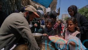 Palestinians block and empty dozens of UN food lorries in Gaza Strip