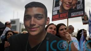 Residents line streets to welcome home Israeli-American hostage