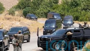 Kurdish separatist fighters in Iraq begin laying down weapons