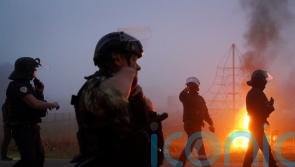 French riot police in early morning clash with migrants in coastal town