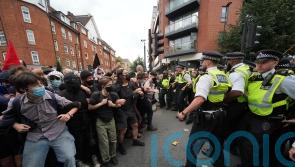 Demonstrators detained by police during rival protests outside asylum hotel